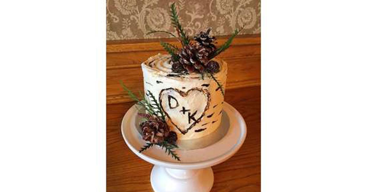 A small wedding cake decorated to look like birch bark.