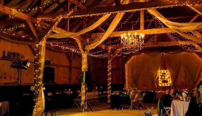 the inside of a barn decorated for a wedding