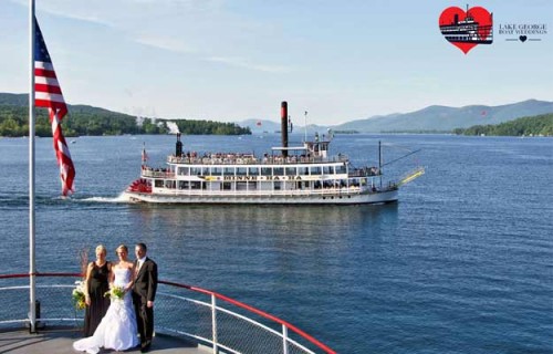 wedding couple getting photos taken on boat on Lake George