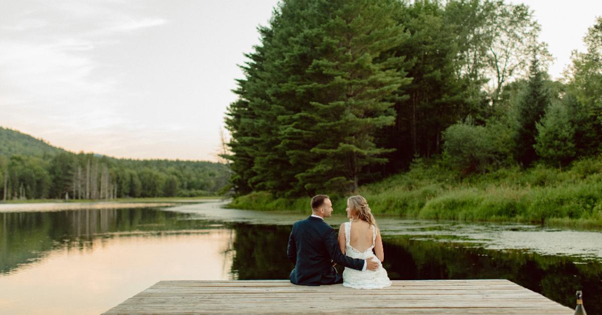 couple seated on a dock smiling