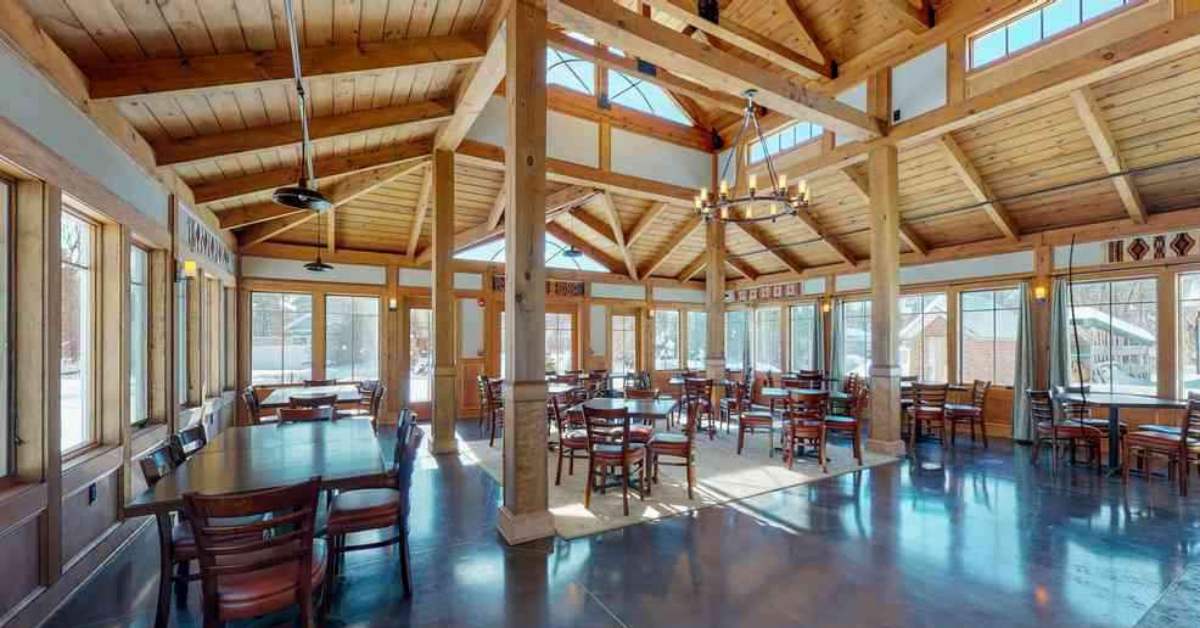 a spacious dining space with windows along the walls