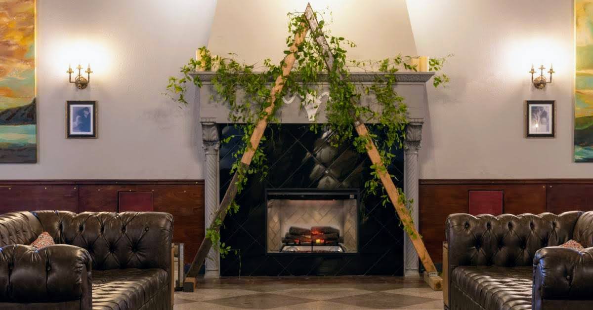 wedding arch over fireplace in hotel lobby